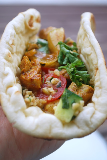 folded flatbread filled with shwarma chicken, tomatoes and cucumbers