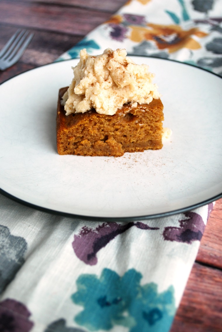 A white plate with a piece of pumpkin gingerbread maple cake
