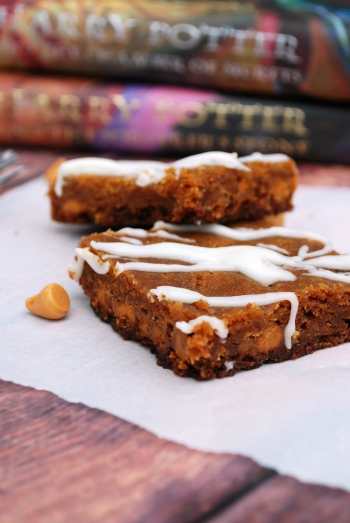 Two slices of butter beer Blondie with Harry Potter books in the background