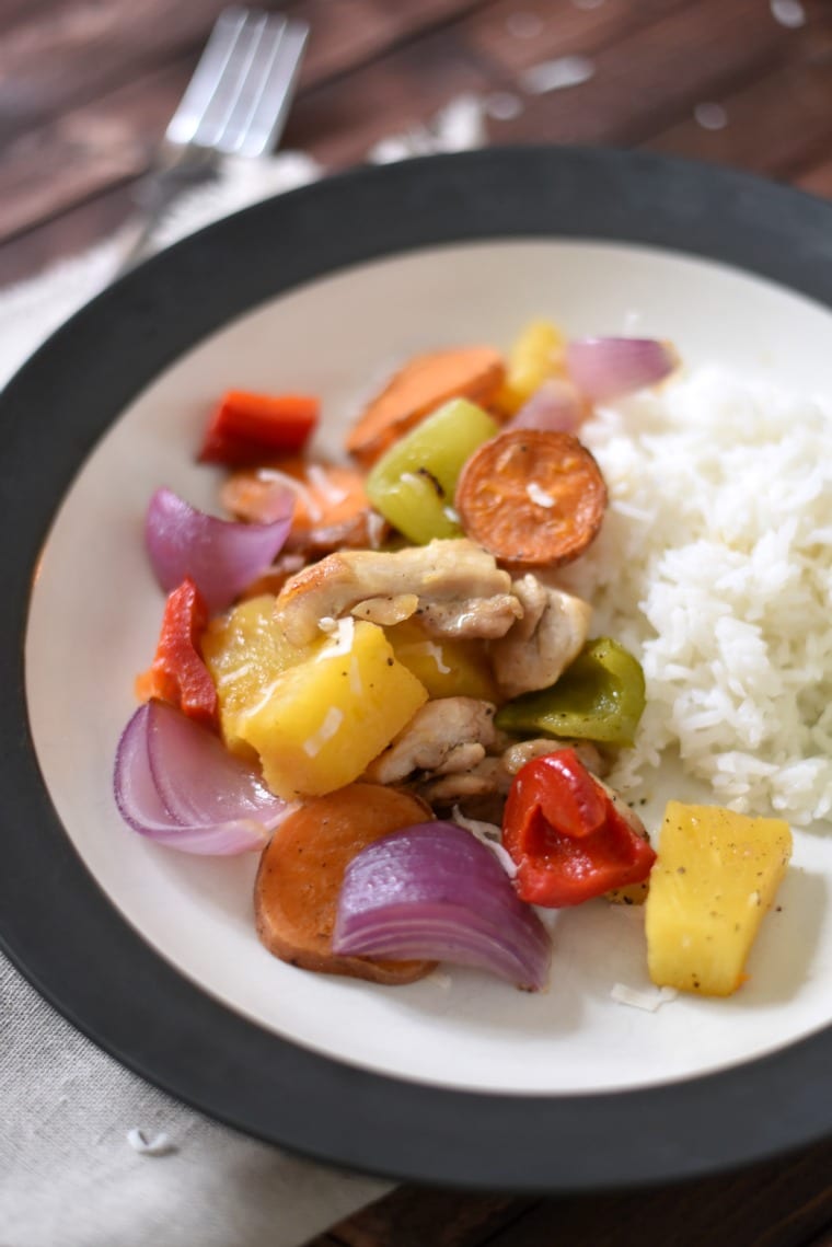 A black and white bowl of Polynesian chicken