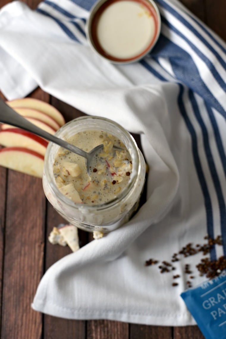 overhead image of mason jar with overnight oats, with spoon and Apple slices