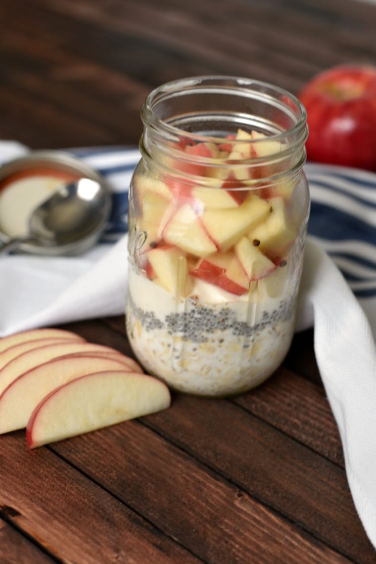 A jar of apple pie overnight oats on a wooden table