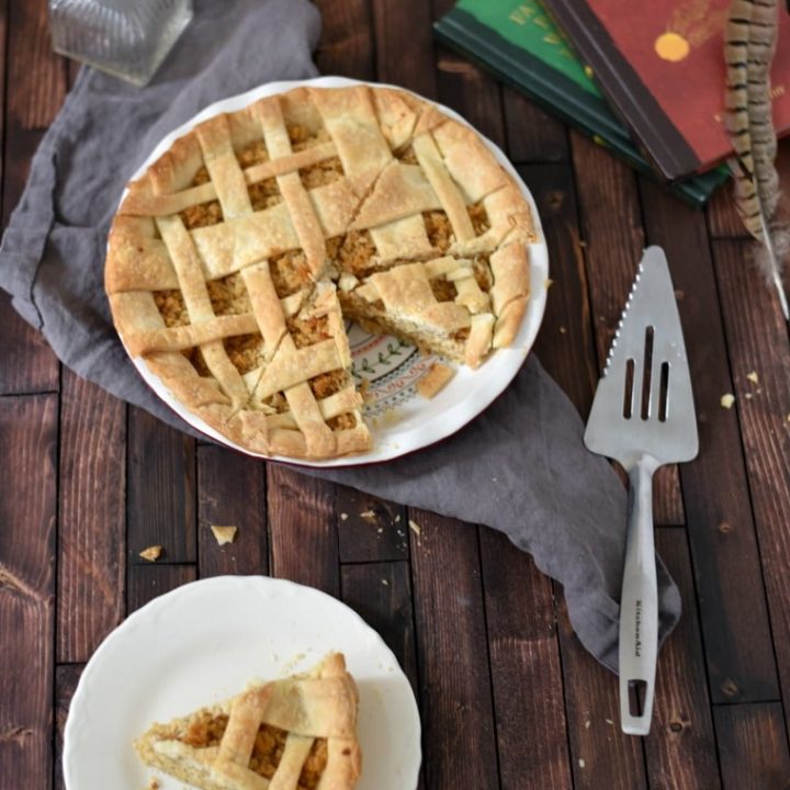treacle tart on plate and in pie plate with serving spatula and books beside