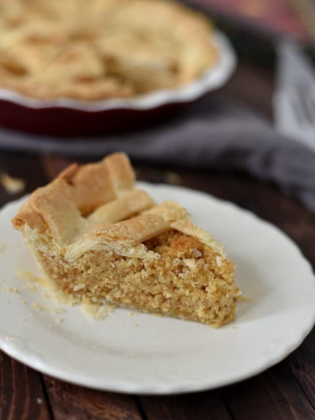 A slice of treacle tart on a white plate