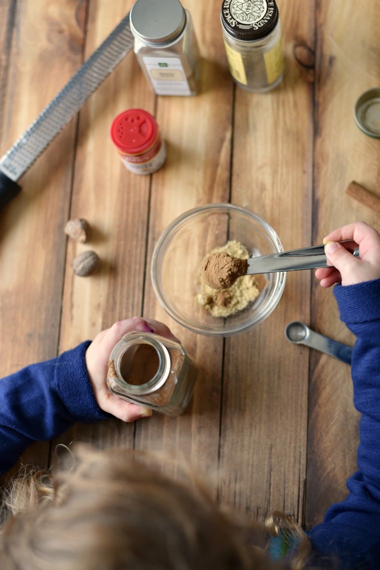 kids hands measuring spices for baking