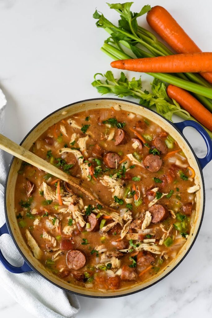 blue cooking pot with chicken sausage gumbo