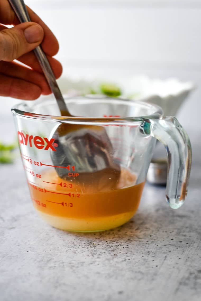 dressing for swedish cucumber salad in glass mixing bowl