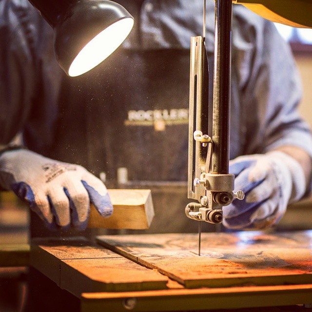 man at saw holding wood