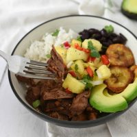 bowl with shredded beef and other ingredients for cuban beef bowl