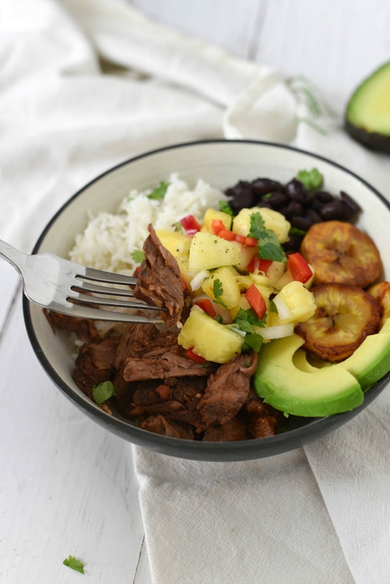 bowl with shredded beef and other ingredients for cuban beef bowl 