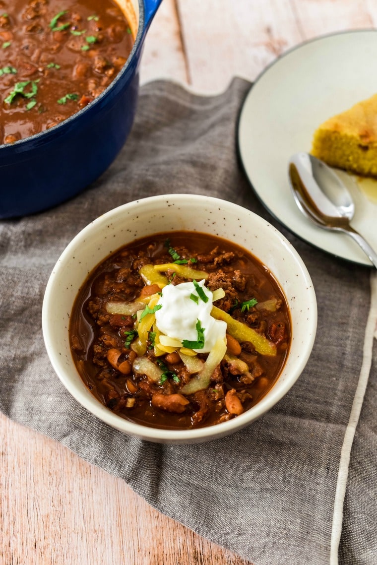 chocolate bison chili with shredded cheese and sour cream