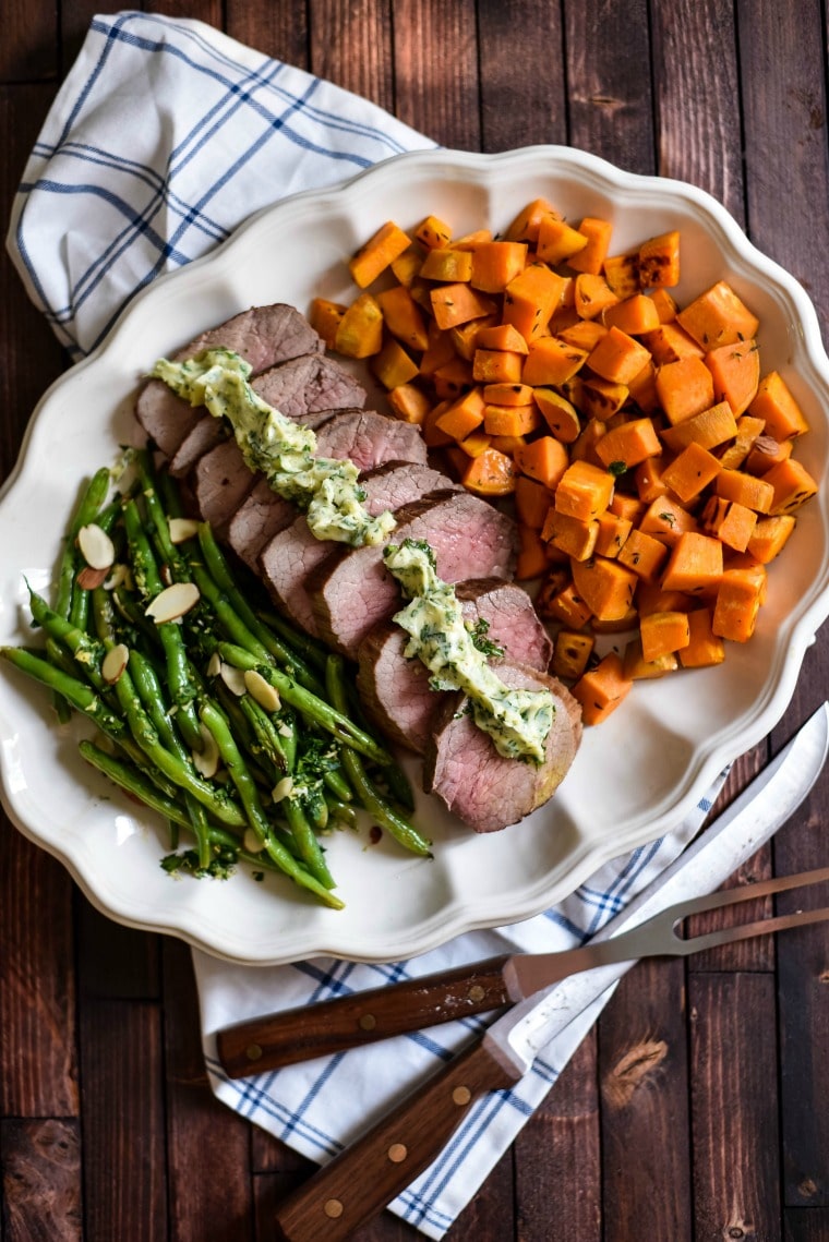 platter with roasted beef, roasted sweet potatoes and green beans with almonds