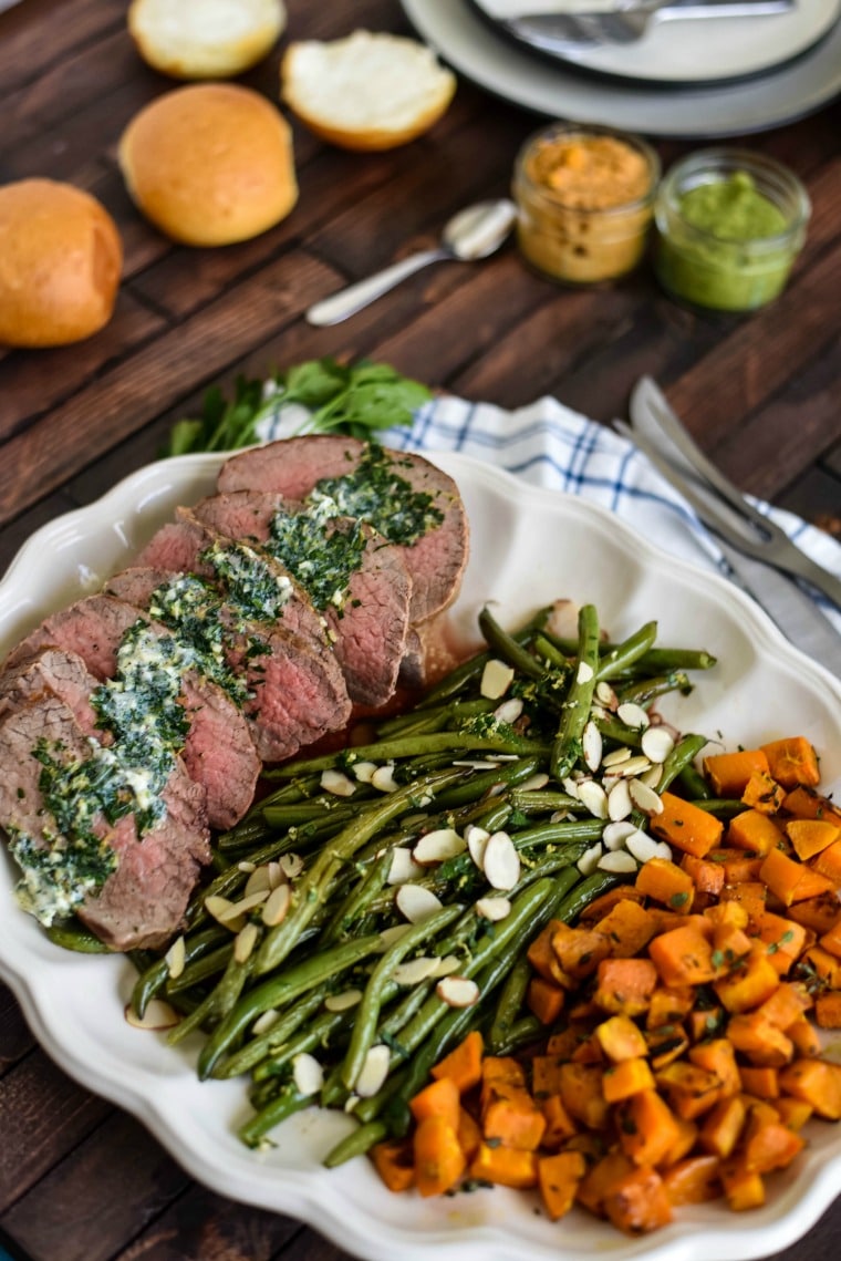 A plate of food on a table, with Steak and Potato