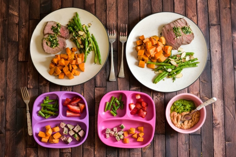 five plates for different family members on a wooden table