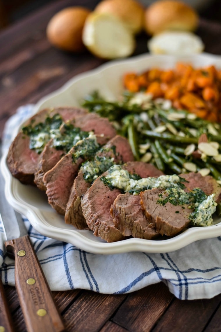 A plate of food on a table, with Steak and Beef