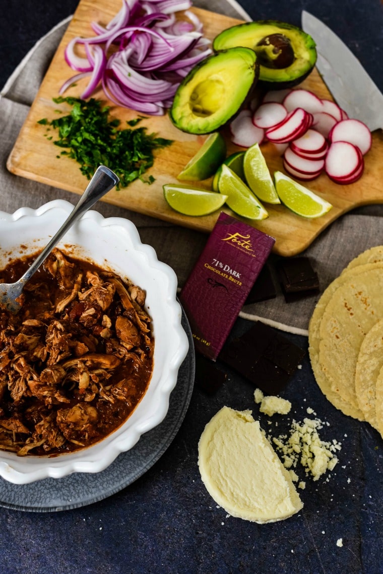 Chocolate mole sauce on chicken with tacos ingredients 