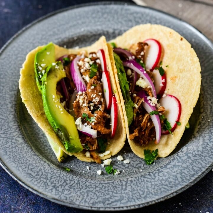 chicken mole tacos on blue plate