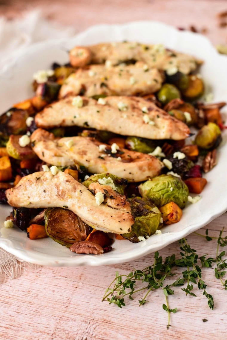 chicken breast on roasted vegetables on plate