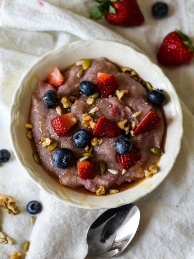 Cornmeal Porridge in bowl with berries and nuts