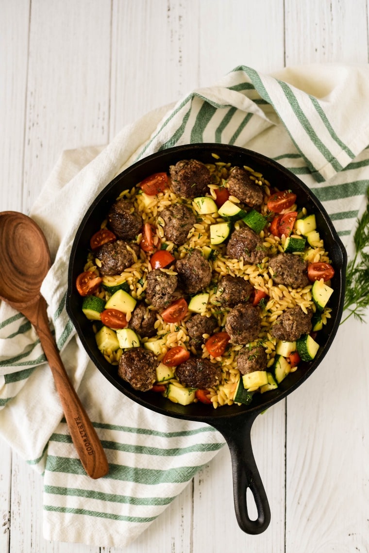 lemon orzo and greek veggies in cast iron skillet