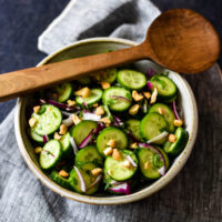 bowl with thai cucumber salad and wooden spoon