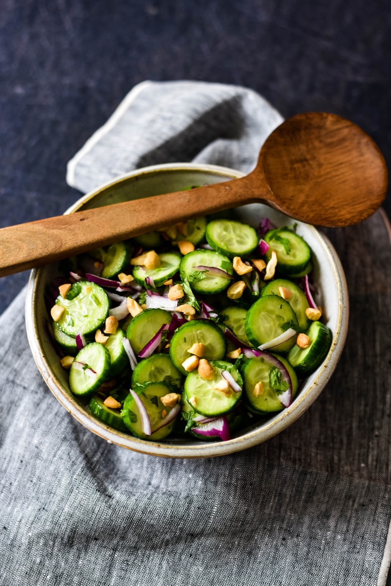 bowl with thai cucumber salad and wooden spoon