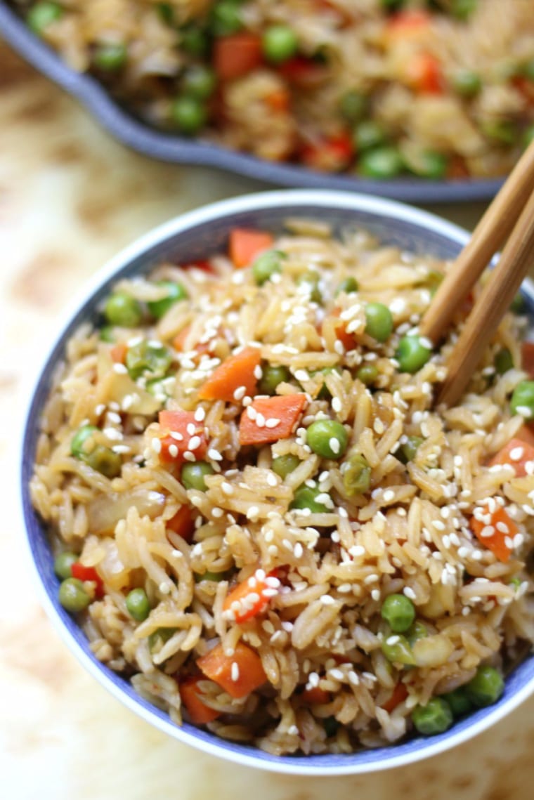 vegetable fried rice in bowl with chopsticks