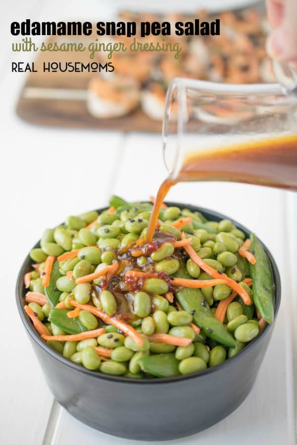 edamame and snap peas in bowl with dressing being poured on