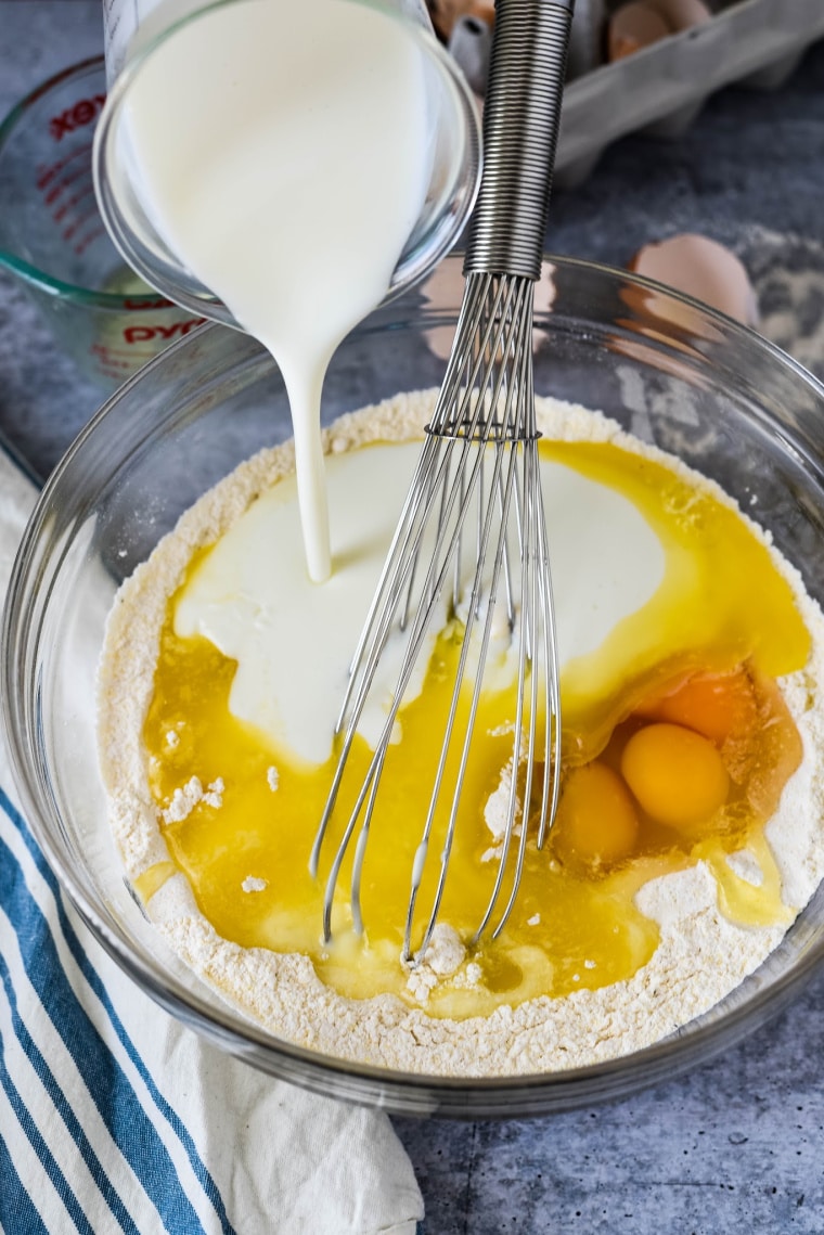 pouring milk into waffle batter