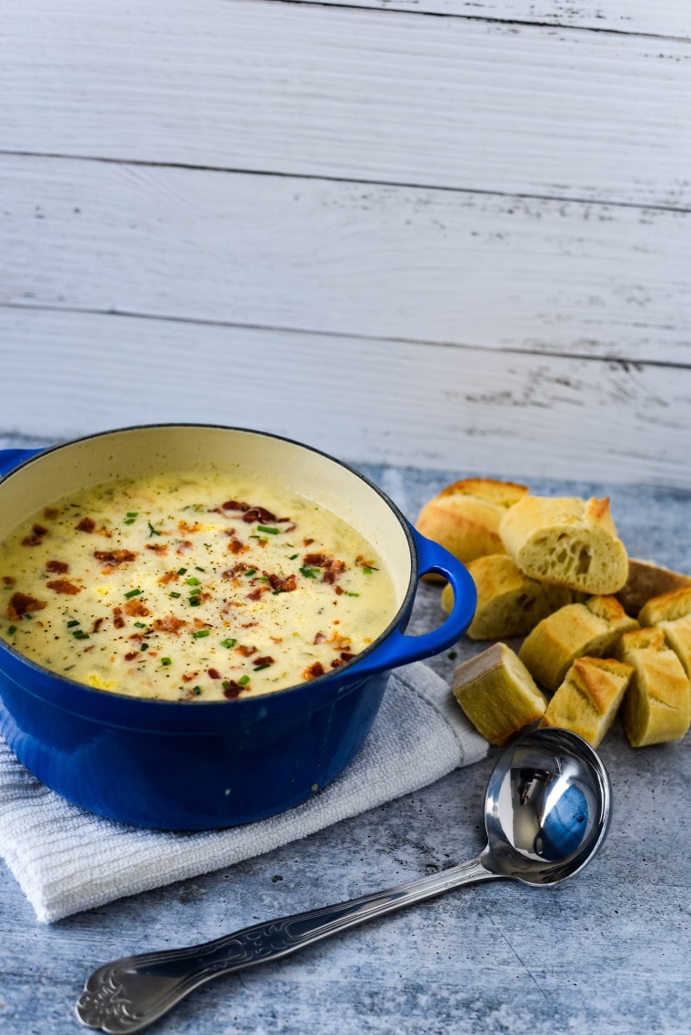 potato soup in blue pot with ladles