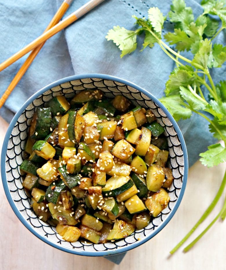 asian zucchini recipe in bowl with cilantro and chopsticks