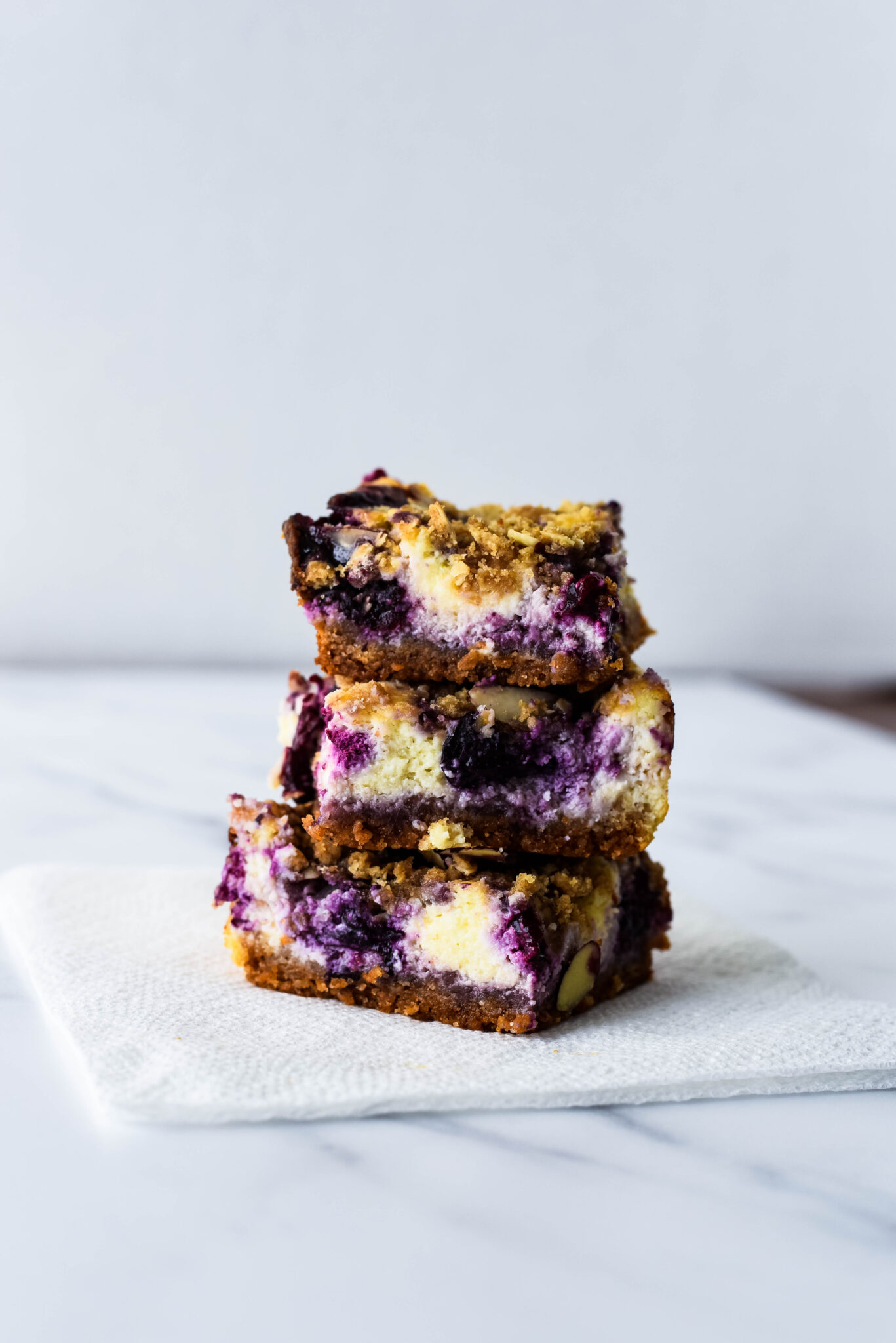 3 blueberry cheesecake bars in a stack