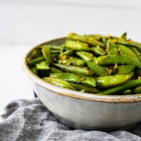 bowl with sugar snap peas with orange and mint