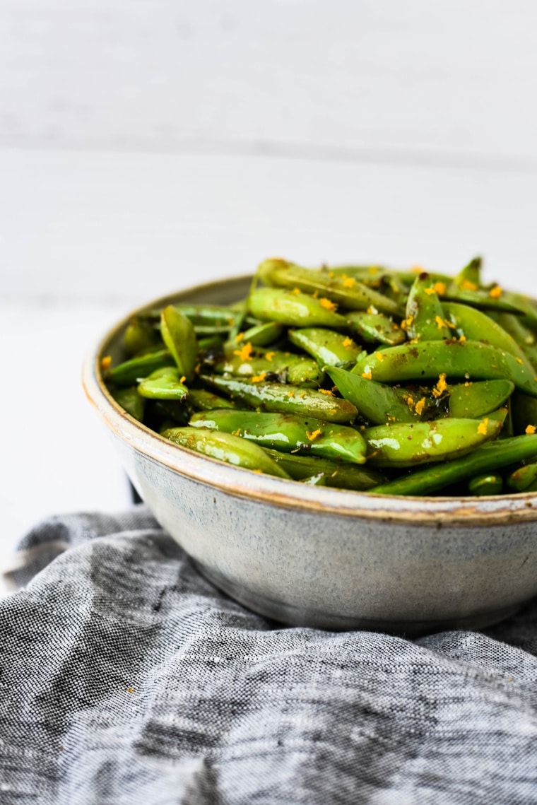 bowl with sugar snap peas with orange and mint