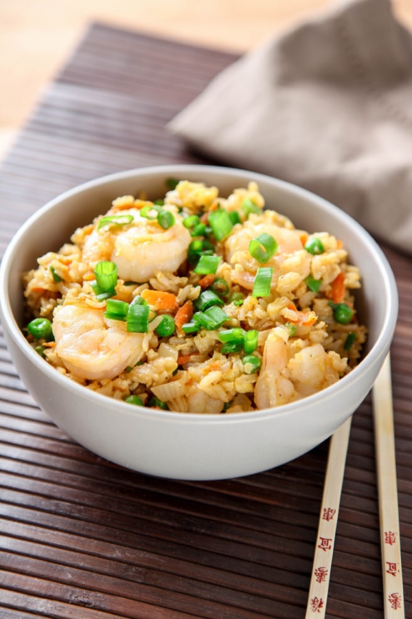 shrimp stir fry in bowl with chopsticks beside