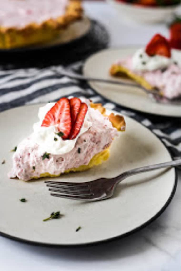 piece of strawberry mousse tart on plate with fork