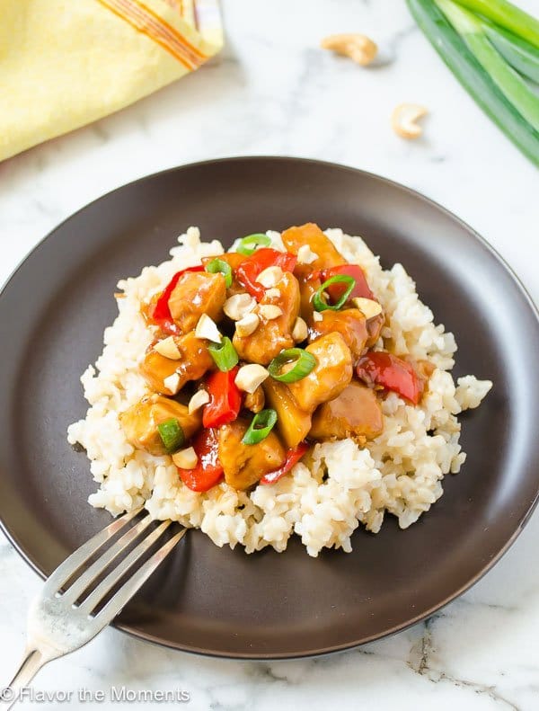pineapple chicken with veggies and rice on grey plate