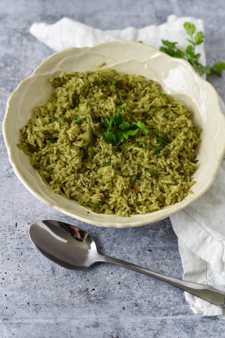 bowl of mexican green rice with spoon