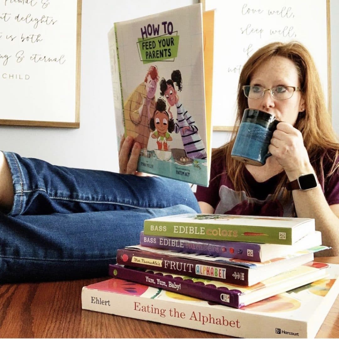 A woman reading a book and drinking coffee