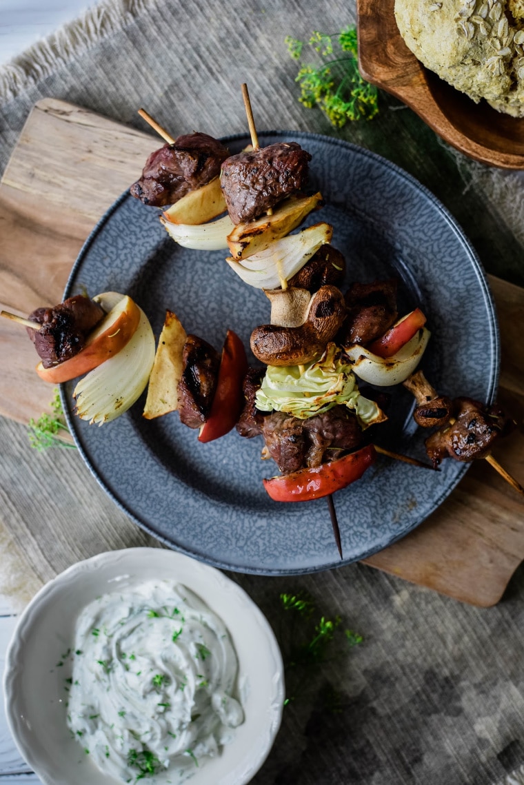 lamb kebabs on blue plate