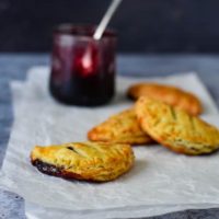 cheese jam turnovers on parchment paper with jam