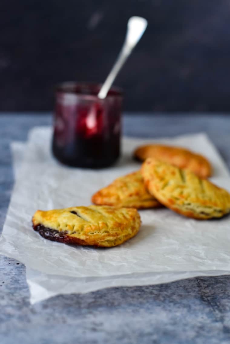 cheese jam turnovers on parchment paper with jam