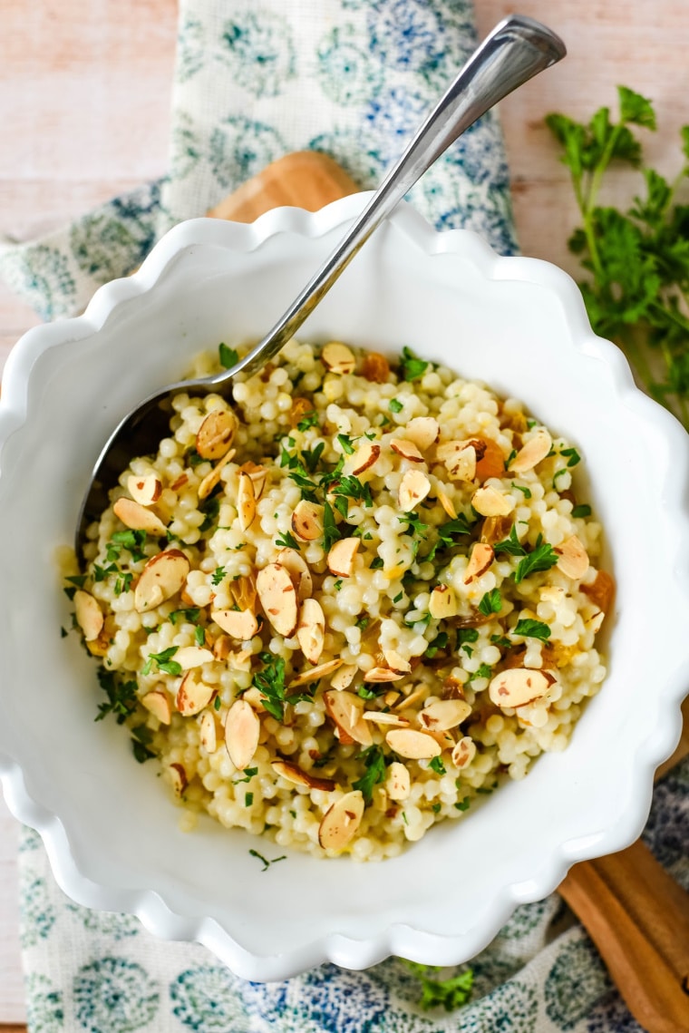 lemon couscous in white bowl with spoon