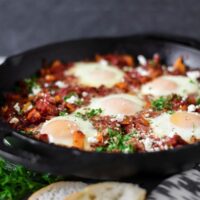 shakshuka in cast iron pan with bread