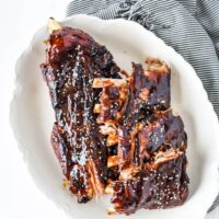 asian sticky ribs on white platter with napkin