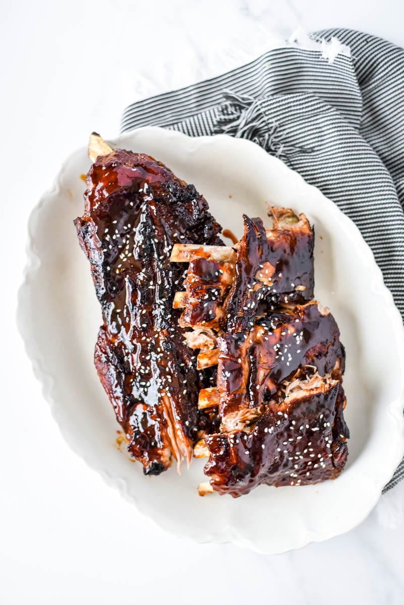 asian sticky ribs on white platter with napkin