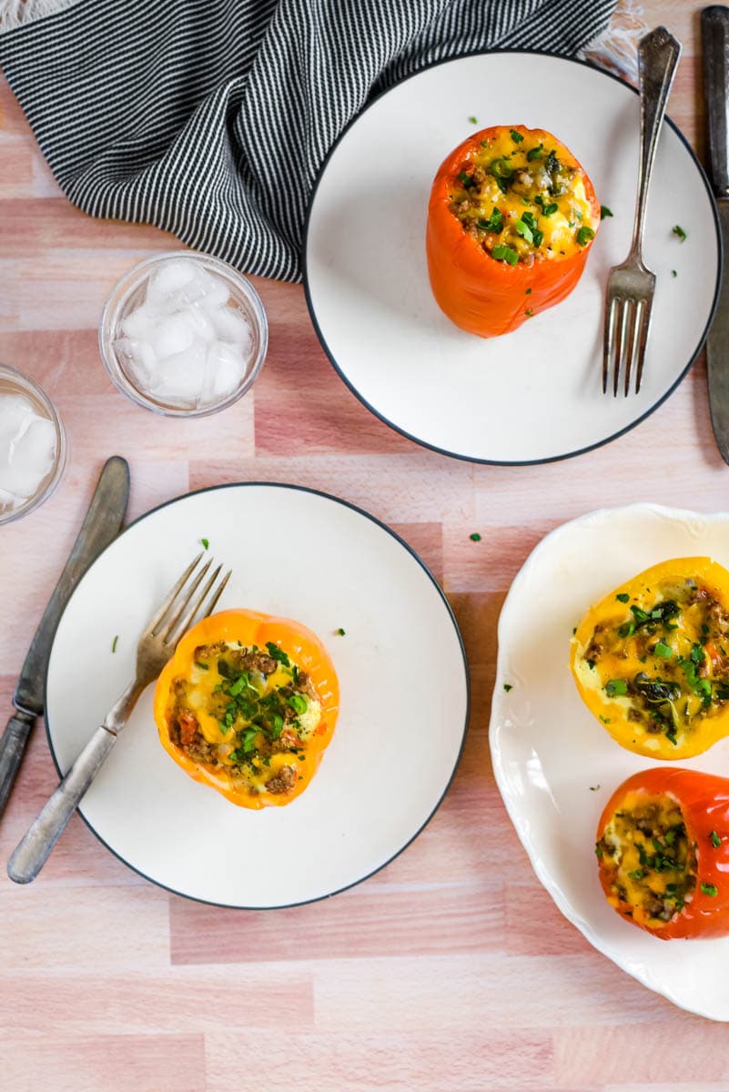 egg stuffed peppers on white plates