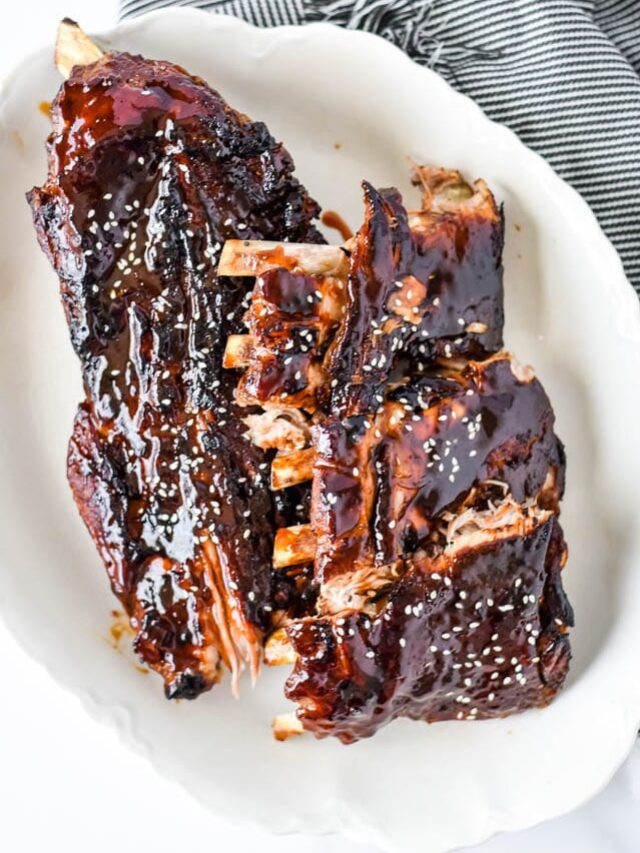 asian sticky ribs on white platter with napkin