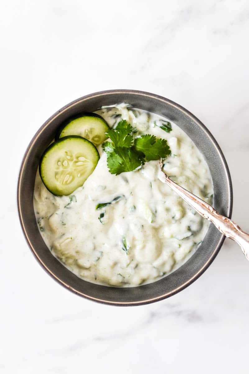 top down view of grey bowl with indian raita inside