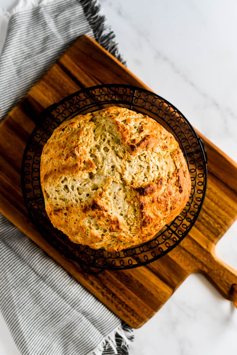 irish soda bread with sourdough on wooden cutting board